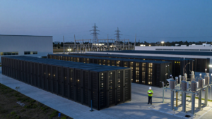 Data center campus and nearby power infrastructure at dusk