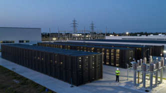 Data center campus and nearby power infrastructure at dusk