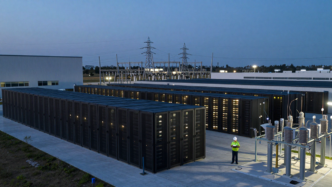 Data center campus and nearby power infrastructure at dusk
