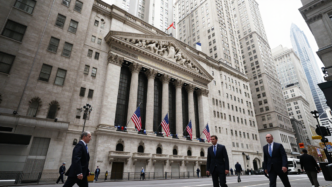 New York Stock Exchange facade and American flags on Broad Street in Manhattan