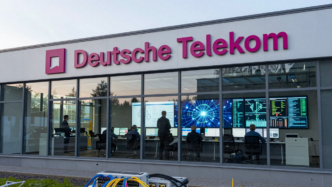 Deutsche Telekom operations center with engineers monitoring telecom network systems.