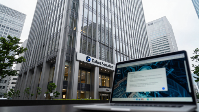 Daiwa Securities office building in Tokyo with a laptop showing a cybersecurity alert