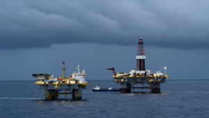 Offshore oil platforms in the Gulf of Mexico beneath storm clouds ahead of Tropical Storm Isaias.
