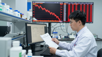 Scientist reviewing clinical trial data beside a falling stock chart in a pharmaceutical laboratory.