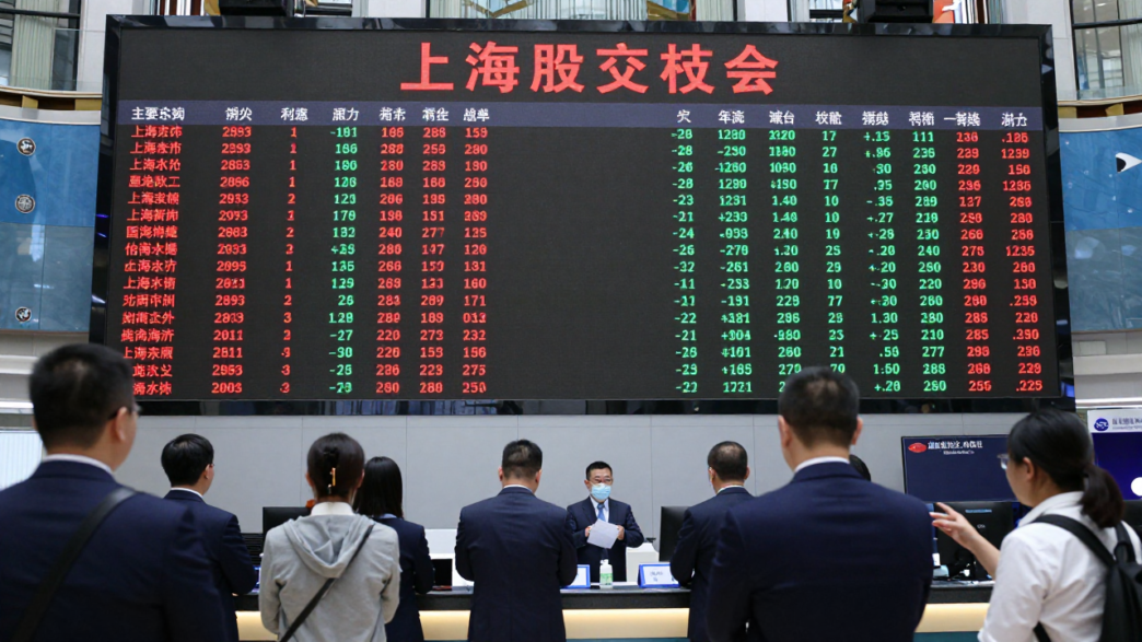 Traders watch market screens in Shanghai as mainland Chinese markets reopen after Golden Week.