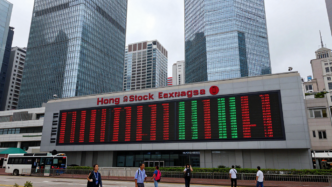 Hong Kong financial district on a quiet trading morning, with market screens showing mixed stock movements.