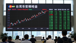 Taiwan stock market board showing the benchmark index rising in a Taipei trading hall.