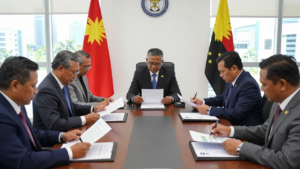 Papua New Guinea officials review economic and budget documents at a meeting in Port Moresby.