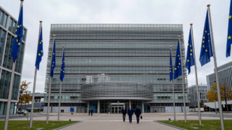 European Commission headquarters and EU flags in Brussels