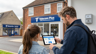 A British household reviewing utility services on a tablet, illustrating Telecom Plus’s Utility Warehouse customer growth.