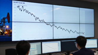 Trading screens displaying a declining WTI crude oil chart near a marked support level.