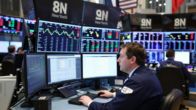 Trader monitors market screens on the floor of the New York Stock Exchange.