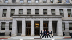 Attorneys approach the federal appeals courthouse in Boston during arguments over Kennedy’s vaccine-panel appointments.