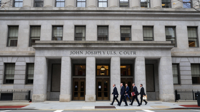 Attorneys approach the federal appeals courthouse in Boston during arguments over Kennedy’s vaccine-panel appointments.