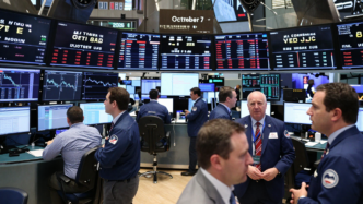 Traders monitor stock and Treasury markets on the New York Stock Exchange.