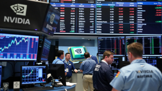 Traders watch rising market charts on an exchange floor during a record-setting session for U.S. stocks.