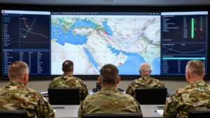 Military planners study a Middle East map in an operations room.