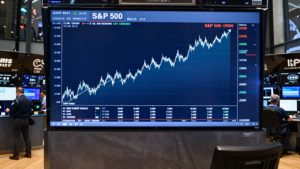 Traders watch a rising S&P 500 chart on a market display.