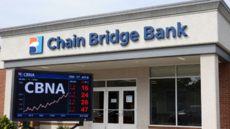 Chain Bridge Bank building in McLean, Virginia, with a rising CBNA stock chart displayed in the foreground.