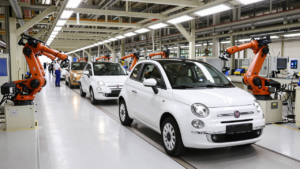 A Fiat 500 hybrid on an automotive assembly line inside an Italian factory.