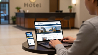 Traveler comparing hotel websites on a laptop in a hotel lobby