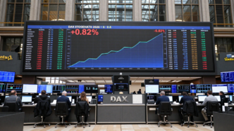Frankfurt trading hall with an electronic display showing the DAX up 0.82%.
