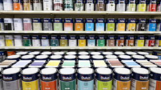 Decorative paint cans and color samples displayed in a Southeast Asian home-improvement store.