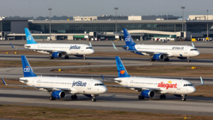 JetBlue and Allegiant passenger aircraft taxiing at an airport