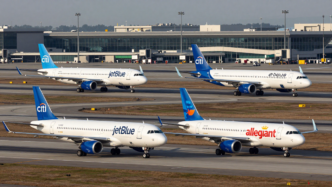 JetBlue and Allegiant passenger aircraft taxiing at an airport
