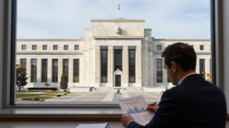 Federal Reserve headquarters in Washington, D.C., with an analyst reviewing inflation charts.