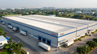 Modern Indian logistics park with a large warehouse and freight trucks