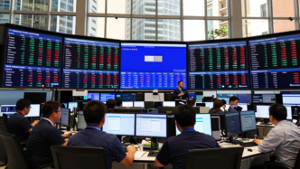 Traders monitor Asian stock indexes, Treasury yields and currencies on electronic screens.