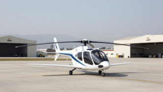 Electric air taxi on an airport apron near hangars