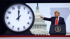 Donald Trump speaks at a rally beside a clock graphic, illustrating the dispute over permanent daylight saving time.