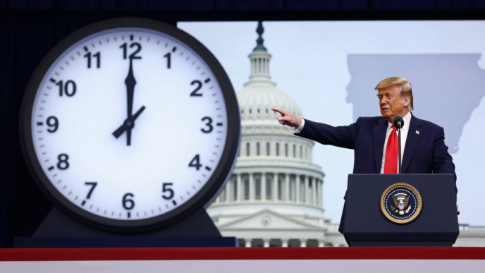 Donald Trump speaks at a rally beside a clock graphic, illustrating the dispute over permanent daylight saving time.