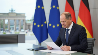 Friedrich Merz in a Berlin government meeting room with German and EU flags