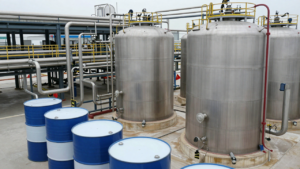 Chemical drums and pipework inside an industrial plant, illustrating China’s probe into EU chemical imports.