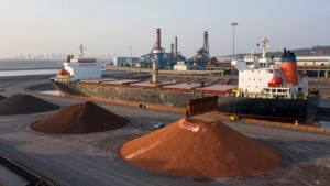 Copper concentrate at a South American export terminal with a bulk ship in the background