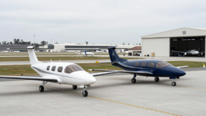 Two electric vertical-takeoff-and-landing aircraft on an airport apron