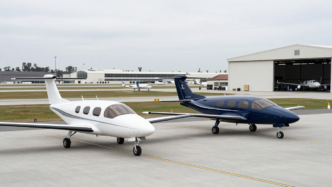 Two electric vertical-takeoff-and-landing aircraft on an airport apron
